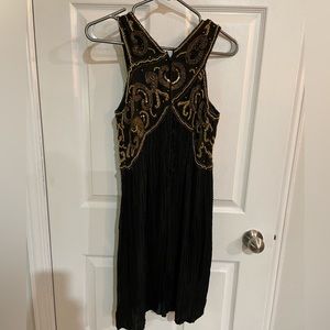 All silk hand beaded black dress with gold beading . Fits as women’s small .